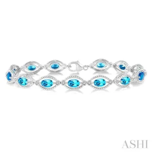 1/10 ctw Round Cut Diamond & 6x4MM Oval Cut Blue Topaz Semi Precious Bracelet in Silver